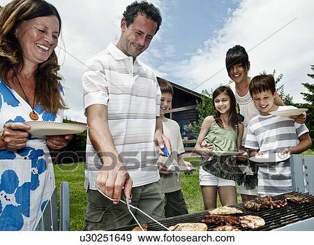 Stock Photo - Family queueing for barbeque. Fotosearch