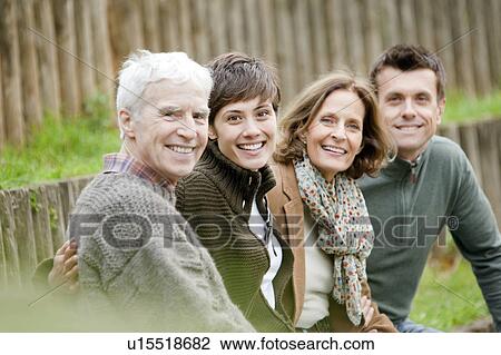 Family sitting in the park View Large Photo Image Stock Image - Family sitting in the park. Fotosearch