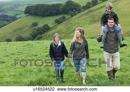 Family walking in the fields View Large Photo Image Stock Image - Family walking in the fields. Fotosearch