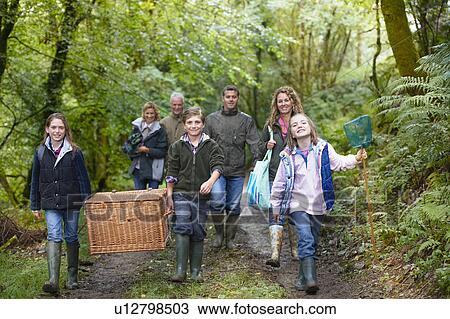 Family walking through the woods View Large Photo Image Stock Image - Family walking through the woods. Fotosearch