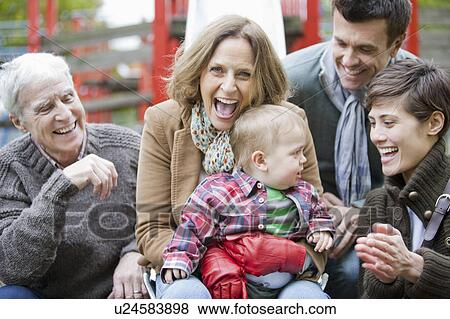 Family with child laughing in the park View Large Photo Image Stock Photo - Family with child laughing in the park. Fotosearch
