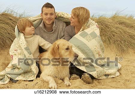 Family with dog, under quilt, on beach View Large Photo Image Stock Photo - Family with dog, under quilt, on beach. Fotosearch