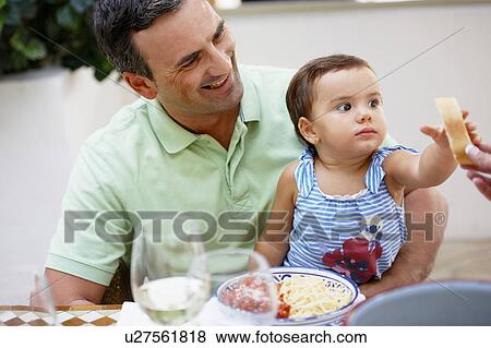Stock Photo - Father and daughter having lunch. Fotosearch