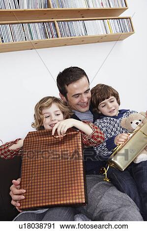 Father and Kids opening gifts View Large Photo Image Stock Image - Father and Kids opening gifts. Fotosearch