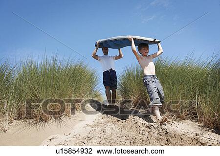 Father and Son Carrying Surf board View Large Photo Image Stock Image - Father and Son Carrying Surf board. Fotosearch