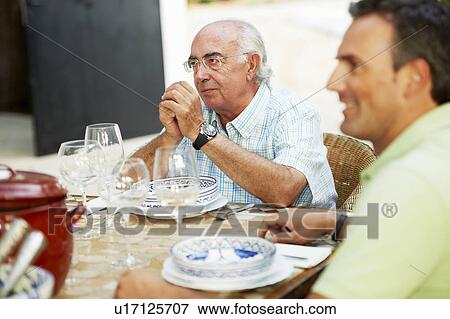 Father and son having lunch View Large Photo Image Stock Photo - Father and son having lunch. Fotosearch