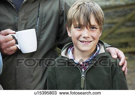 Stock Image - Father and son having tea. Fotosearch