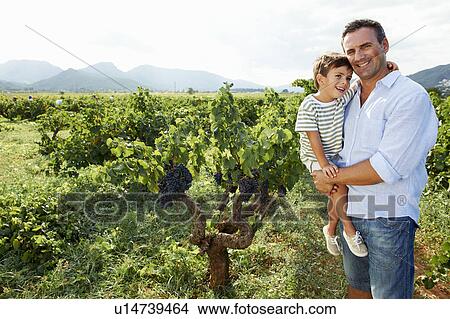 Picture - Father and son in vineyard. Fotosearch