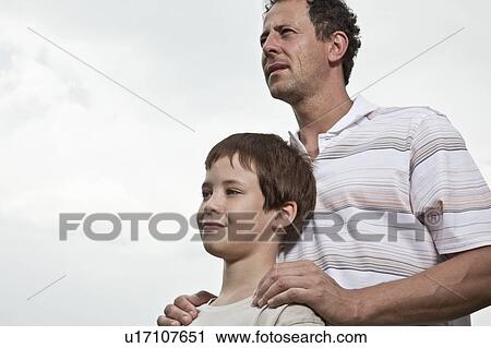Father and son look into distance View Large Photo Image Stock Image - Father and son look into distance. Fotosearch