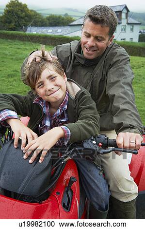 Father and son on quad bike View Large Photo Image Stock Image - Father and son on quad bike. Fotosearch