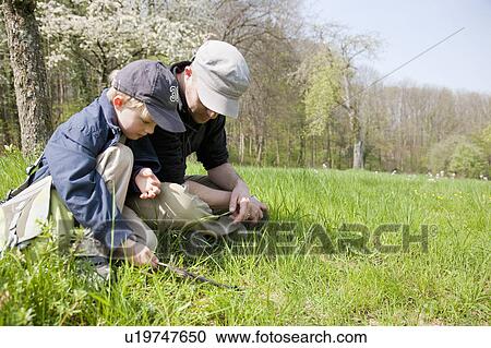 Father and son relaxing in nature View Large Photo Image Stock Image - Father and son relaxing in nature. Fotosearch