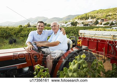 Father and son sitting on tractor View Large Photo Image Stock Image - Father and son sitting on tractor. Fotosearch