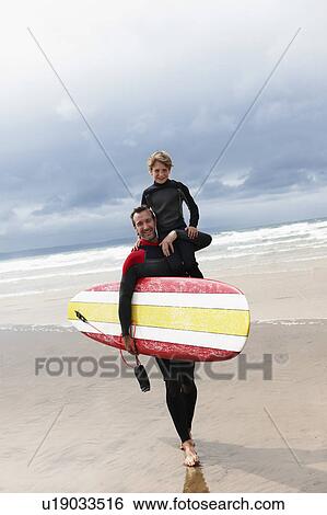 Father and son surfing View Large Photo Image Stock Photograph - Father and son surfing. Fotosearch