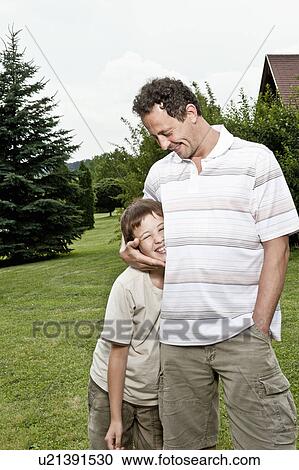 Stock Image - Father clutching son. Fotosearch