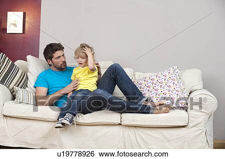 Stock Photograph - Father taking care of son. Fotosearch
