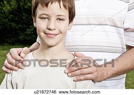 Stock Photograph - Fathers hand's on son's shoulders. Fotosearch