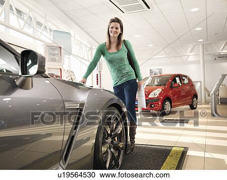 Female customer looks at car View Large Photo Image Stock Image - Female customer looks at car. Fotosearch