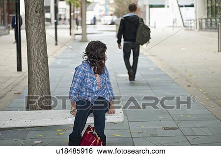 Female looking at male walking in street View Large Photo Image Stock Photograph - Female looking at male walking in street. Fotosearch