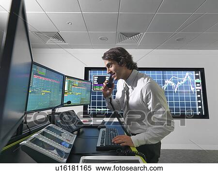 Stock Photography - Financial trader with screens. Fotosearch