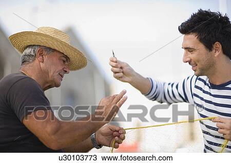 Stock Image - Fisher preparing net. Fotosearch