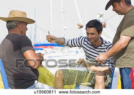 Fisher preparing their net View Large Photo Image Stock Image - Fisher preparing their net. Fotosearch