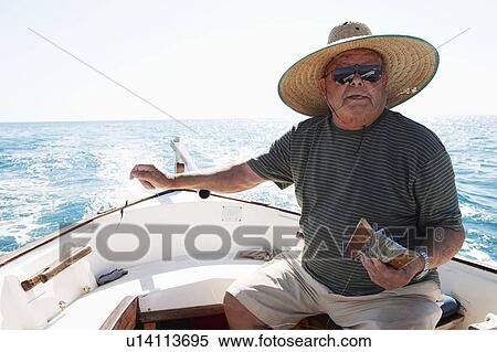 Fisherman at sea in fishing boat View Large Photo Image Stock Photography - Fisherman at sea in fishing boat. Fotosearch