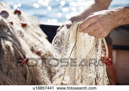 Fisherman holding nets View Large Photo Image Stock Image - Fisherman holding nets. Fotosearch