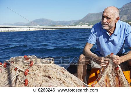 Stock Photograph - Fisherman holding nets. Fotosearch