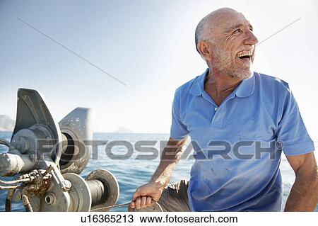 Fisherman on fishing boat View Large Photo Image Stock Image - Fisherman on fishing boat. Fotosearch