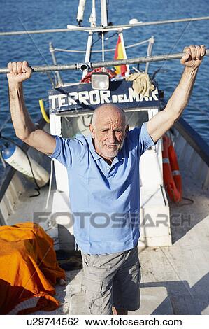 Fisherman on fishing boat View Large Photo Image Stock Image - Fisherman on fishing boat. Fotosearch