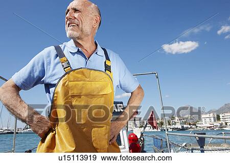 Fisherman on fishing boat View Large Photo Image Stock Photo - Fisherman on fishing boat. Fotosearch