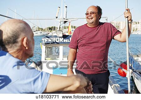 Stock Image - Fishermen on fishing boat. Fotosearch
