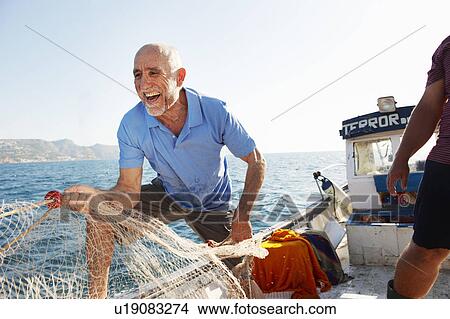 Picture - Fishermen pulling in nets. Fotosearch