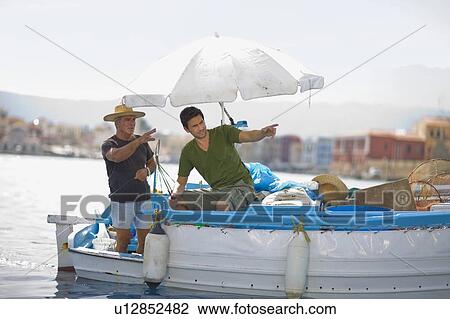 Stock Image - Fishers on boat. Fotosearch