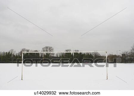 Stock Image - Football pitch covered in snow. Fotosearch