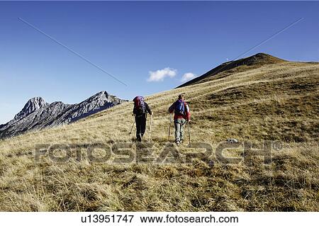Stock Photo - Friends enjoying hill walk. Fotosearch