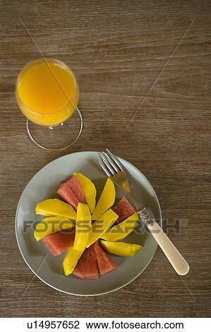 Fruit plate with a glass of orange juice View Large Photo Image Stock Image - Fruit plate with a glass of orange juice. Fotosearch