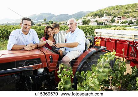 Stock Image - Generational family sitting on tractor. Fotosearch
