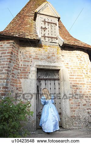 Stock Photo - Girl as a princess, by the chapel. Fotosearch
