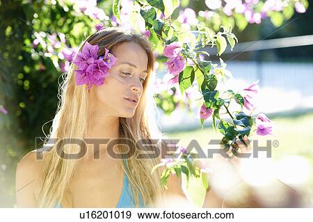 Stock Photo - Girl by the pool with flower in her hair. Fotosearch
