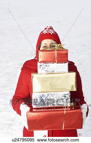 Girl carrying presents in snow View Large Photo Image Stock Photography - Girl carrying presents in snow. Fotosearch