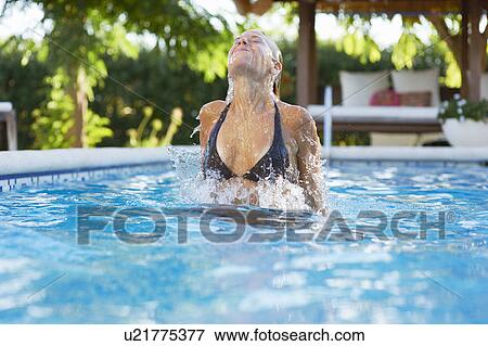 Girl coming out of the water in pool View Large Photo Image Stock Photo - Girl coming out of the water in pool. Fotosearch