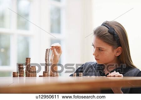Girl Counting money at a table View Large Photo Image Stock Image - Girl Counting money at a table. Fotosearch