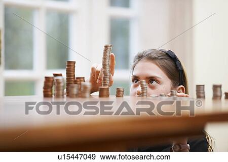 Girl counting piles of money View Large Photo Image Stock Photo - Girl counting piles of money. Fotosearch