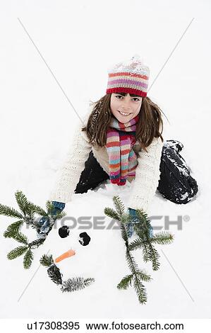 Girl decorating snowman View Large Photo Image Stock Photography - Girl decorating snowman. Fotosearch