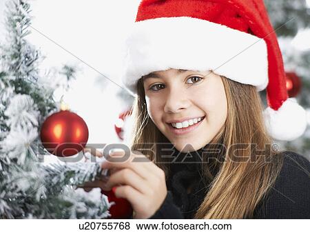 Girl decorating the christmas tree View Large Photo Image Stock Photo - Girl decorating the christmas tree. Fotosearch