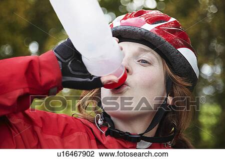 Girl drinking from water bottle View Large Photo Image Stock Image - Girl drinking from water bottle. Fotosearch