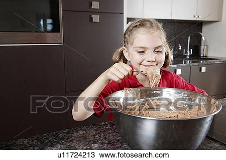 Girl eating cake mix from the bowl View Large Photo Image Stock Image - Girl eating cake mix from the bowl. Fotosearch