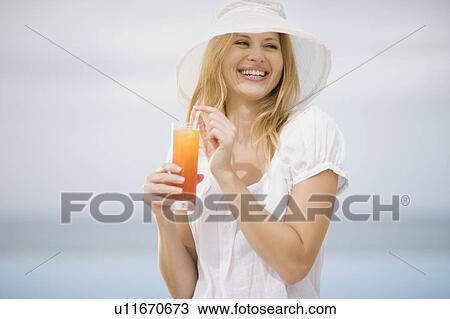 Stock Image - Girl having a drink. Fotosearch