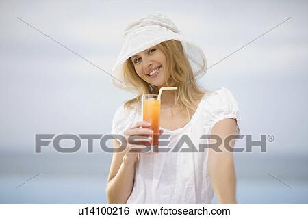 Girl having a drink View Large Photo Image Stock Photograph - Girl having a drink. Fotosearch